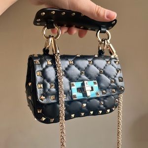 Valentino Garavani Micro Rockstud Spike Leather Top Handle Bag.